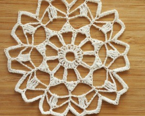 Starched white doily against a wooden background