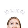 Upper half of a woman's face with the word acne written above it