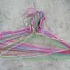 Pile of wire hangers on cement background