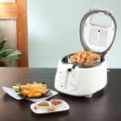 Home Deep Fryer with Fried chicken and chicken and sauces on table