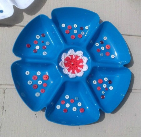 Serving trays decorated with buttons and a crocheted center, in red, white and blue.