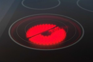 Red lit burner on a glass top stove