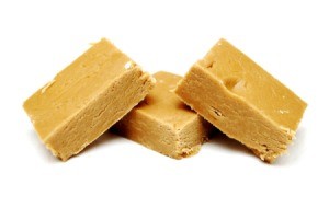 Three pieces of peanut butter fudge against a white background