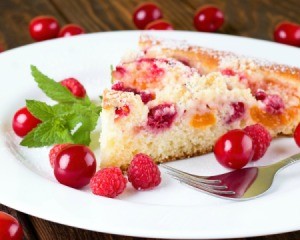 Dump cake (cake with canned mixed fruit  in it) on a white plate.