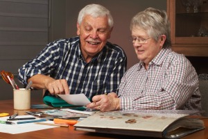 Senior couple working on a scrapbook together