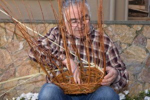 Senior man weaving a basket