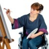 Woman in wheelchair painting