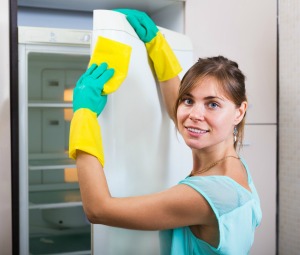 Woman cleaning Exterior of a Refrigerator