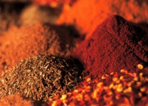 Close up image of piles of several different spices