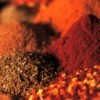 Close up image of piles of several different spices