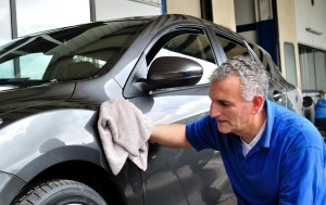 Man wiping car exterior with a cloth