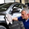 Man wiping car exterior with a cloth