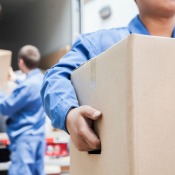 Movers carrying boxes from a truck