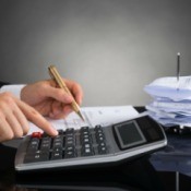 Using calculator to balance checkbook with a large stack of receipts