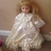 child doll in white satin dress