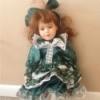 doll wearing a green dress and hat