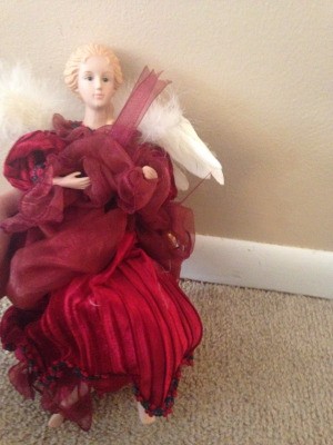 doll wearing a fancy red dress