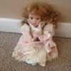 doll in pink dress with pleated ruffles