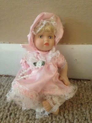 small doll in pink dress