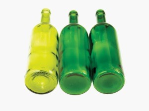 Three empty green wine bottles against white background