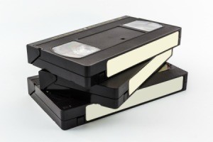 Three blank VHS tapes stacked against a white surface