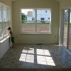 Child Looking out Window in a room with vinyl flooring