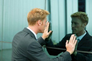 Man looking intently at reflective wall