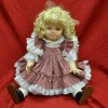 blonde doll in pink flowered and white dress