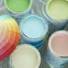 Gallon paint cans with several different colors and had holding paint color sample strips