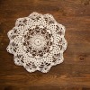 crochet lace doily on dark wood background