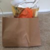 Two shopping bags with items inside.
