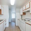 Old fashioned kitchen with white laminate cabinets and white Formica Counters