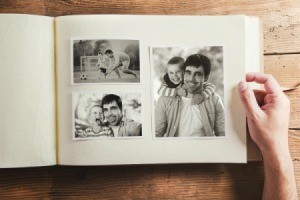 Looking at a photo album showing pictures of a man and his family