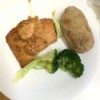Baked Salmon with Marinade on a plate with a baked potato and broccoli