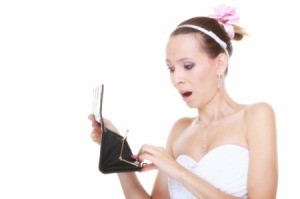 Bride looking at empty wallet in shock