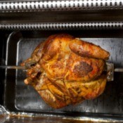 Home rotisserie oven with chicken on spin