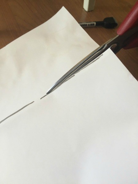 Cutting the paper stencil out.