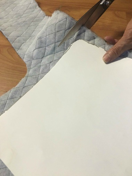 Cutting padded fabric for the chair.
