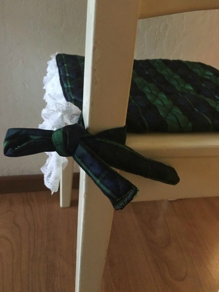 Cushion tied to the back of the chair.