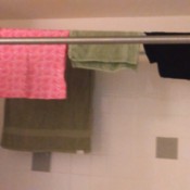 laundry drying on curtain tension rods