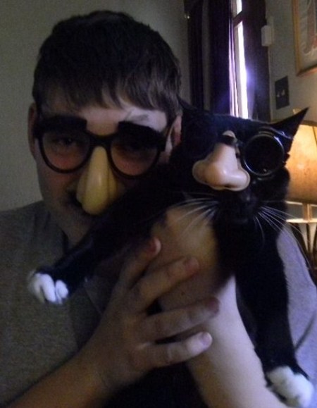 Mittens wearing glasses and false nose