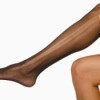 Women's leg with black hose that have a run in them