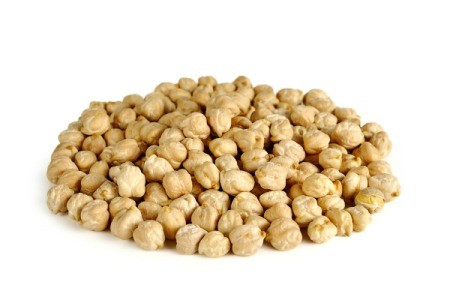 Pile of dried garbanzo beans on white background