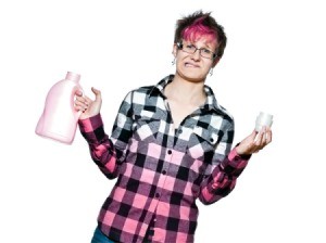 Distressed woman in shirt that is white hombre to pink holding laundry detergent bottle