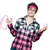 Distressed woman in shirt that is white hombre to pink holding laundry detergent bottle