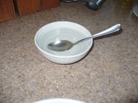 A bowl with a spoon in crepe batter.