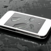 Smart Phone with large drops of water on and around it