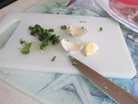 Linguine with Fresh Clam Sauce - Peeling Garlic and chopping basil.
