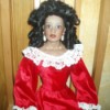 doll wearing a fancy red dress