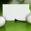 Blank card golf balls and golf tees displayed against a green background